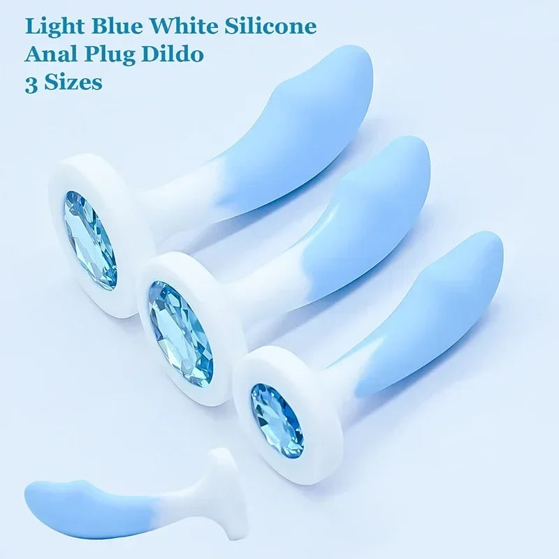 Light blue and white silicone anal plug with three sizes on a light blue background.