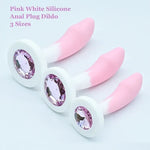 Pink and white silicone anal plug  with gemstones on a light gray background.