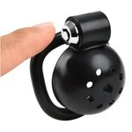 Black Chastity cage with a handle held by a hand on a white background