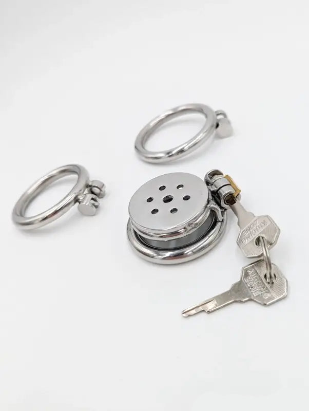 Flat metal chastity cage with two rings, secure lock, and keys