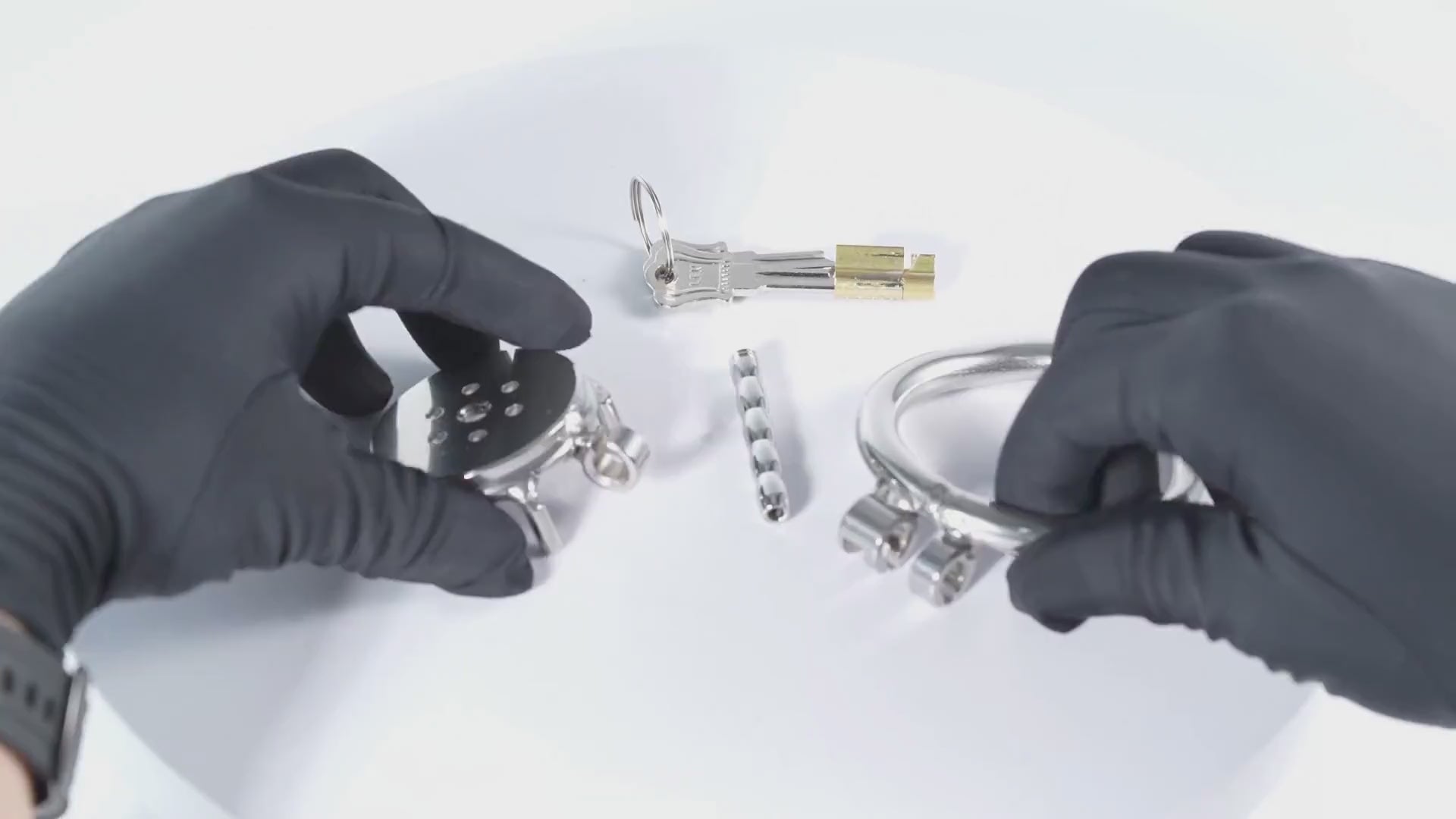 Flat metal chastity cage unboxing and setup with rings, lock, and keys