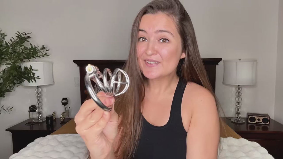 Metal chastity cage demonstration with rings, lock, and keys