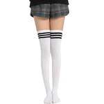 White knee-high socks with black stripes worn with plaid shorts on a white background